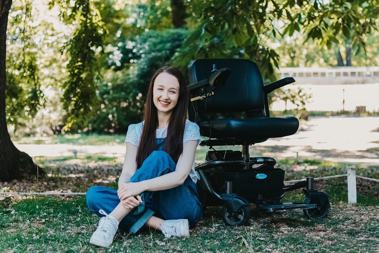 Woman sitting next to mobility chair