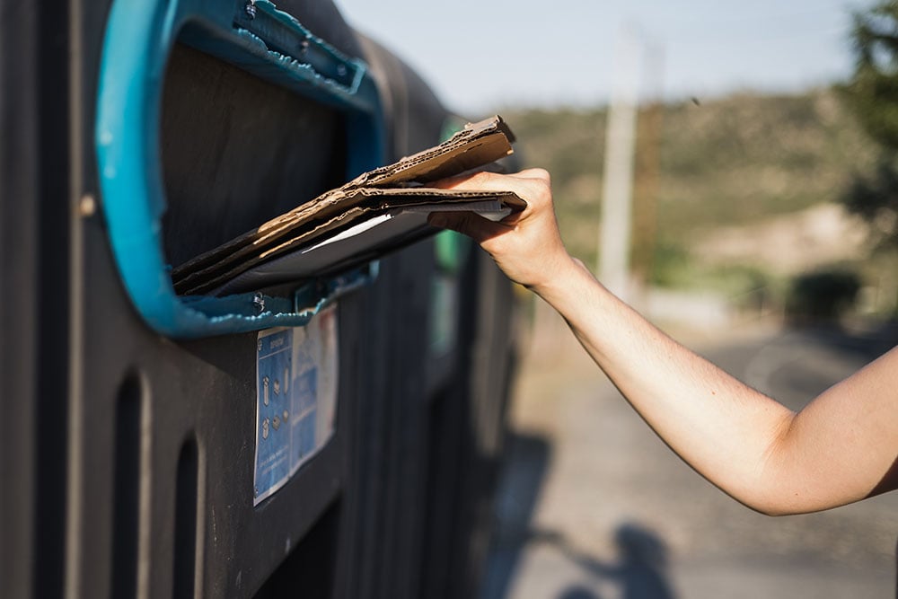 Placing cardboard into local recycling bin